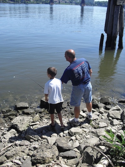 father & son fishing at the park. fishing